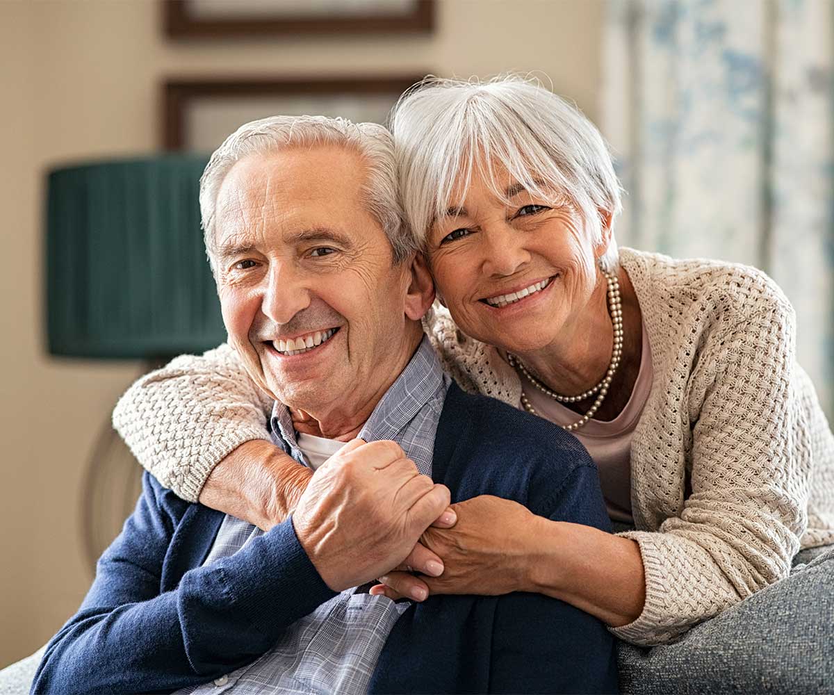 Couple having a cuddle on the lounge